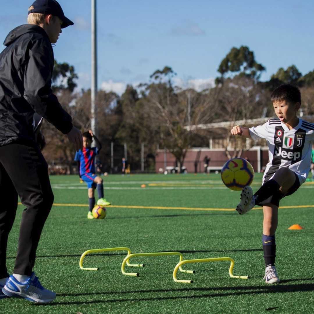 Coach working with a young player